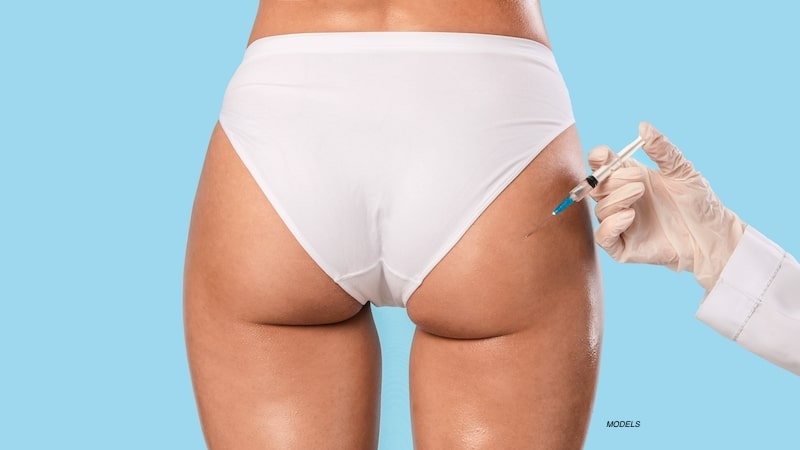 Woman getting injection in her buttock.